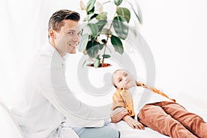 Pediatrist in white coat examining child
