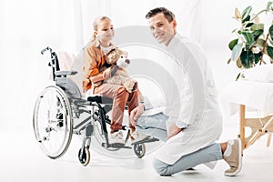 Pediatrist in white coat and kid with teddy bear