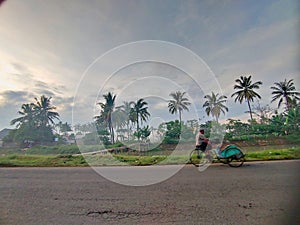 A pedicab on the road with beautiful nature background