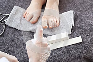 Pedicure in a beauty salon. foot disinfection with an antibacterial agent.