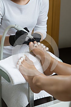 Pedicure at the beauty salon nail polish fixative lacquer woman foot