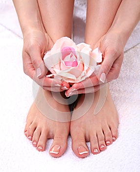 Pedicure on legs and beautiful manicure on hands closeup