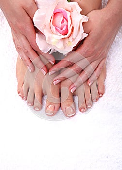 Pedicure on legs and beautiful manicure on hands closeup