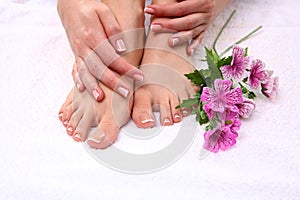 Pedicure on legs and beautiful manicure on hands closeup