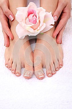 Pedicure on legs and beautiful manicure on hands closeup