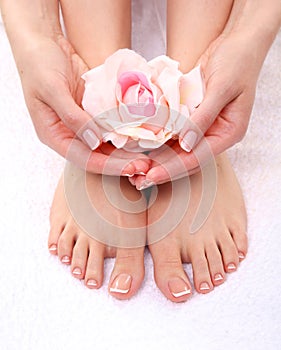 Pedicure on legs and beautiful manicure on hands closeup