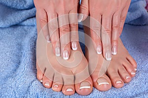 Beauty and Elegance: Pedicure and Manicure on Young Female Feet and Hands