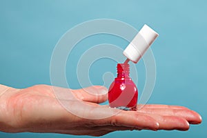 Pedicure manicure red nail polish on female palm