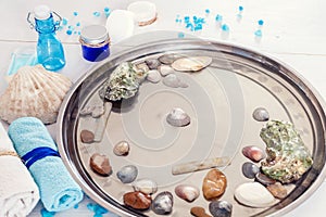 Pedicure and manicure in the spa salon with seashells and stones