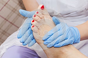 Pedicure moisturizing cram after dead skin remover foot rasp woman in nail salon.