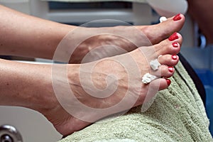 Pedicure in red nail polish