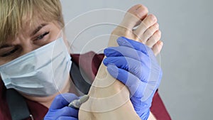 Pedicure SPA procedure in the beauty salon. Peeling feet. Electric apparatus for pedicure. Close up, selective focus.