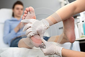 Pedicure SPA procedure in the beauty salon. Peeling feet pedicure procedure. Electric apparatus for pedicure.