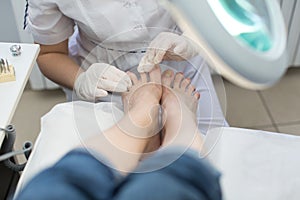 Pedicure SPA procedure in the beauty salon. Peeling feet pedicure procedure. Electric apparatus for pedicure.