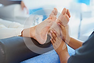 Pedicures are so relaxing. a woman having her feet massaged at a beauty spa.