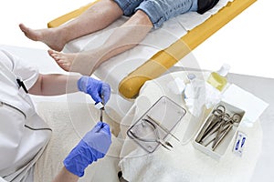 Pedicurist cleaning professional instruments after doing pedicure