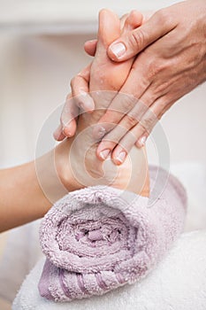 Pedicurist massaging a customers foot