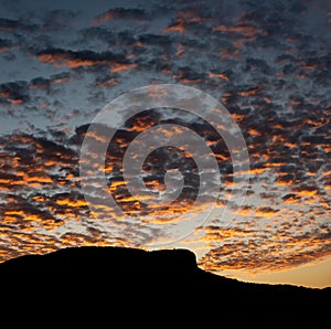 Pedra Branca neighborhood, Palhoca, Brazil with silhouette of the hill, sky at sunset with colorful clouds, infinity of colors in