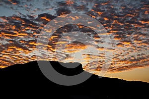 Pedra Branca neighborhood, Palhoca, Brazil with silhouette of the hill, sky at sunset with colorful clouds, infinity of colors in