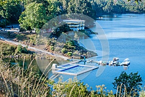 PedrogÃÂ£o Grande PORTUGAL - 10 June 2020 - Bank of the river ZÃÂªzere with floating pool and anchorage for recreational boats