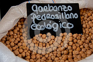 Pedrosillano chickpea or organic arietinum cicer in open white sack to show chickpeas with organic chickpea sign, aerial view,