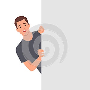 Peeking behind the wall with man hold his hands on edge of blank with copy space concept