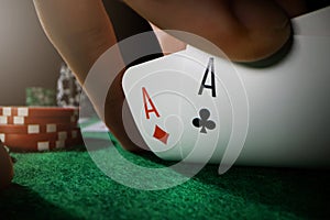 Peeking at pocket aces. playing poker in casino with ace cards