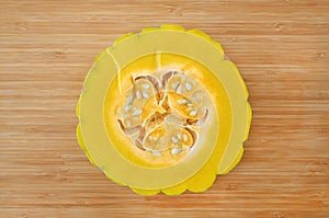 Peel and dissect half pumpkin in white plate against wood background, cross section