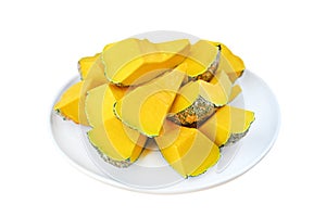 Peel and dissect pumpkin in white plate against white background, cross section