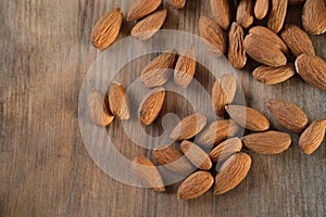Peeled almond nuts are in bulk on a wooden table, edible seed kernels. food concept, confectionery ingredient,nutritional fitness