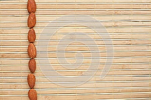 Peeled almonds lying on a bamboo mat