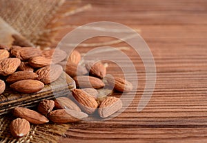 Peeled almonds. A pile of raw almonds on a wooden table. Nuts photo. Country style