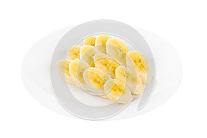 Peeled banan slices on a plate isolated photo