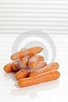 Peeled carrot pile on the table.