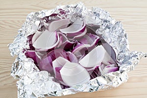 Peeled and chopped red onions in tin foil