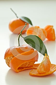 Peeled clementines with leaves