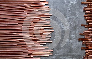 Peeled copper conductors of a wire on a gray background and springs from a copper wire photo