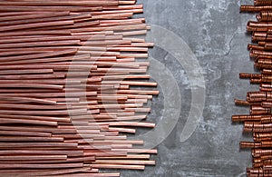 Peeled copper conductors of a wire on a gray background and springs from a copper wire