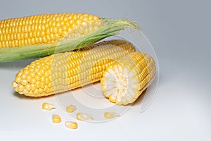 The peeled ear of corn, a piece of and seeds on a white, isolated