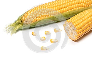 The peeled ear of corn, a piece of and seeds on a white, isolated