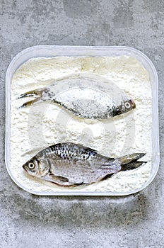 Peeled fish in flour