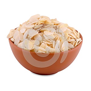 Peeled flaked almonds in brown bowl isolated on white background, copy space