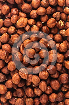 Peeled fresh golden hazelnuts close up in bulk top view