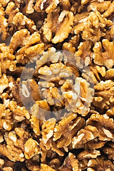 Peeled fresh golden walnuts close up in bulk top view