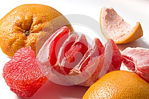 Peeled fresh juicy grapefruit pulp and peel isolated on white background