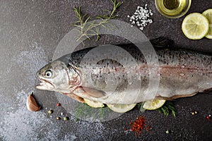 Peeled fresh salmon trout prepared with salt, dill and lemon for cooking baking