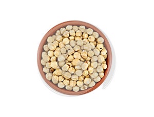 Peeled hazelnuts in a terracotta bowl on white background.