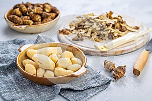 Peeled Jerusalem artichoke, raw topinambour bulbs on kitchen table