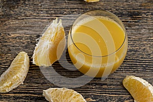 peeled juicy oranges and orange juice on the table