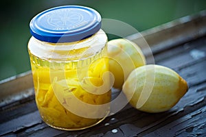 Peeled lemons and lemon peels in a jar lemoncello